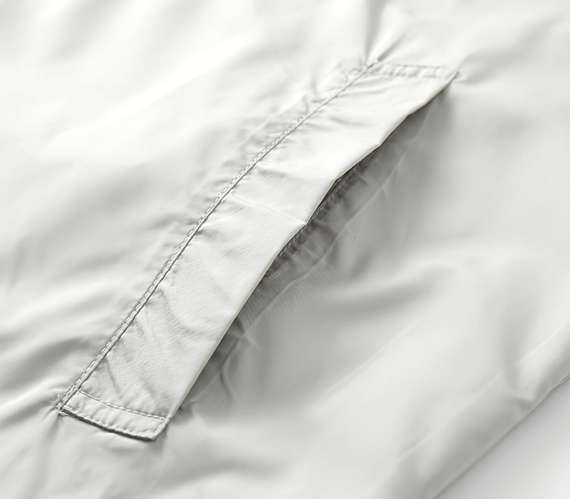 Close-up of the pocket detail on the Casual Light Thin Breathable Hooded Patchwork Jacket in gray, featuring sleek stitching.